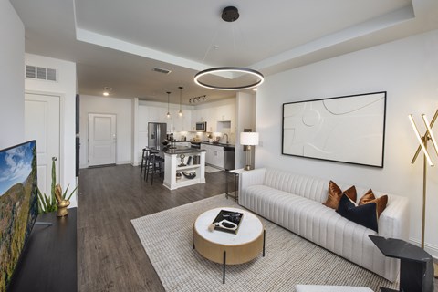 A modern living room with a white sofa and a coffee table.